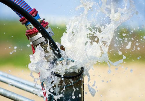 Pumping air from compressor into from new constructed water bore or well as process of cleaning and filtrating water.